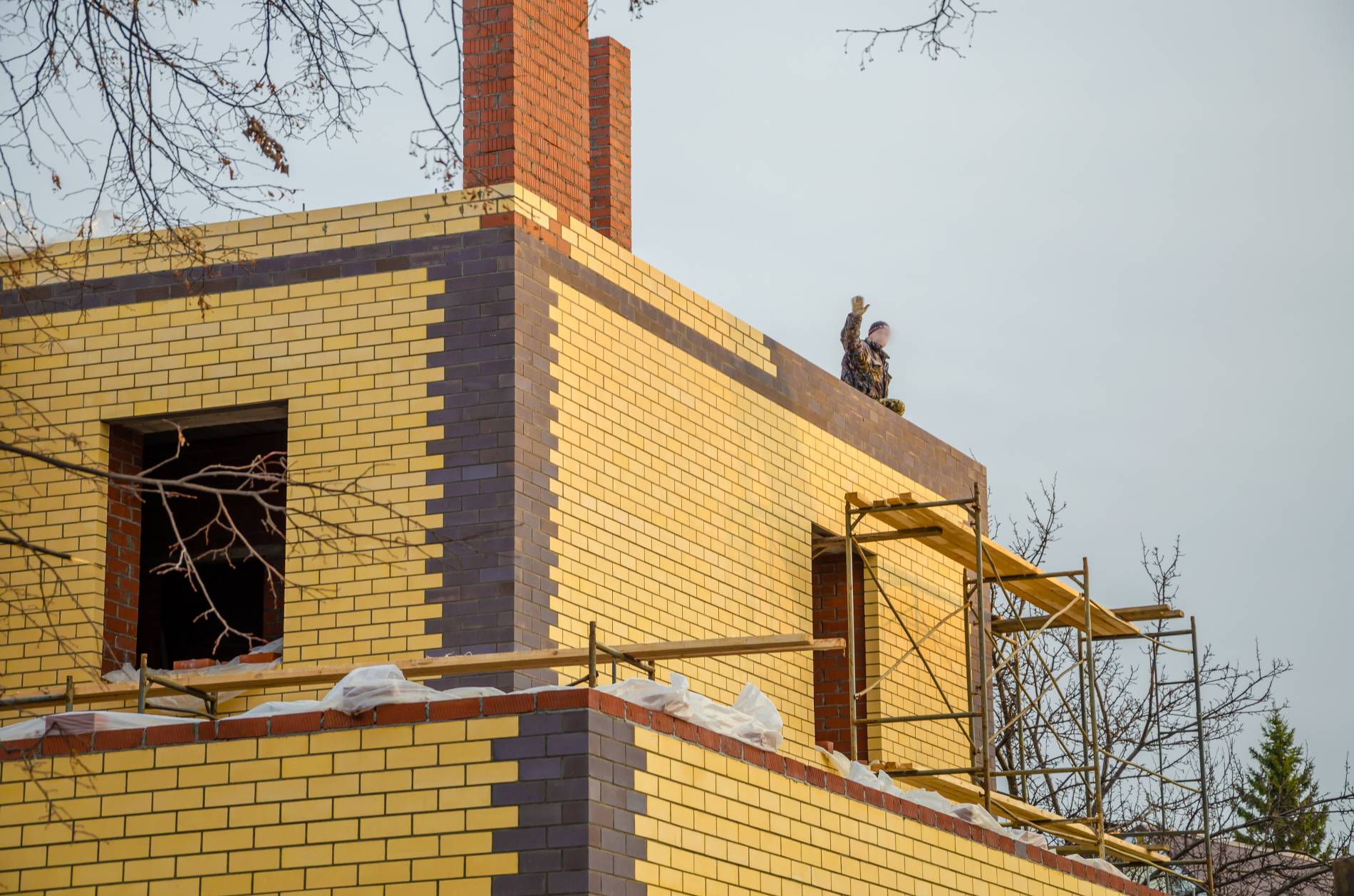 brick-house-being-built-with-yellow-brick-words-brick-side_1900x1258