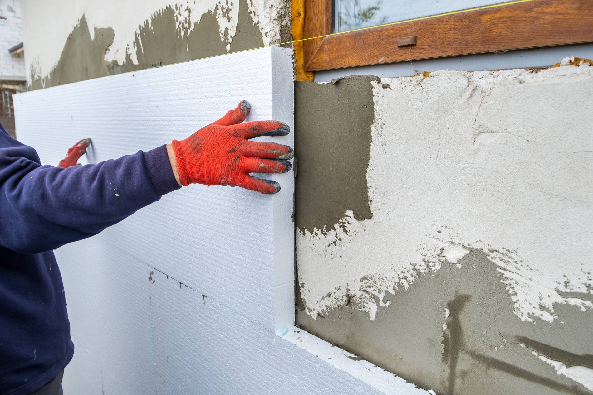 construction-worker-installing-styrofoam-insulation-sheets-house-facade-wall_1900x1267